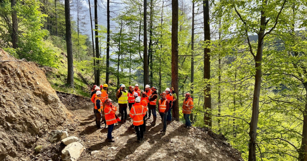 A group of men standing in a woodland
